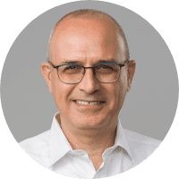Smiling bald man wearing glasses and a white shirt is Mr. Nir Ben Moshe.