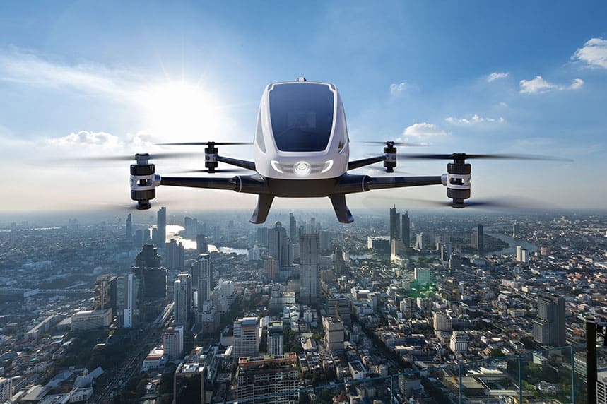 Autonomous drone flying over a cityscape with the sun in the background, maintaining contact throughout its operation.