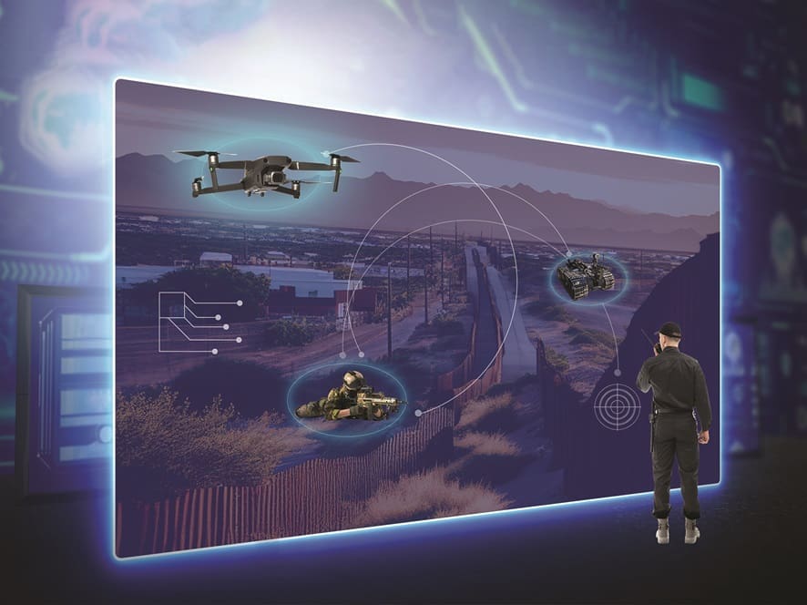 A person interacts with a large, futuristic display showing military drones and data visualizations, suggesting a scenario of advanced surveillance or drone management.